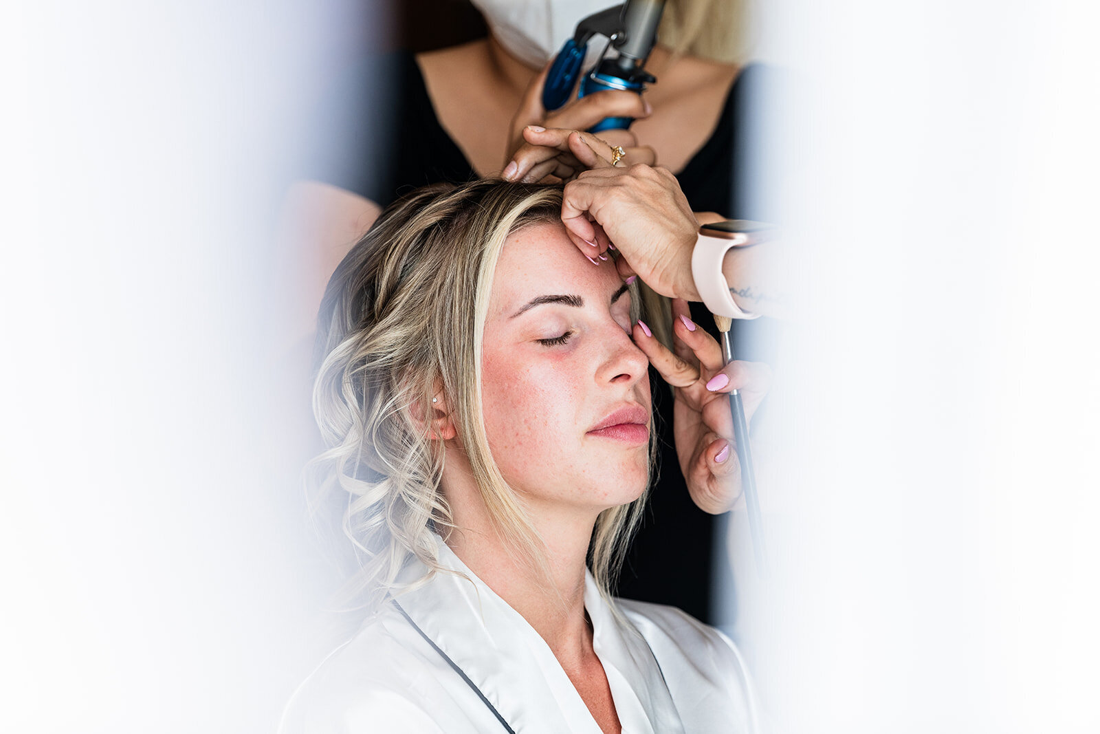 A behind-the-scenes moment of the bride getting her hair styled before the wedding ceremony, captured by CMH Studios in a candid, editorial style.