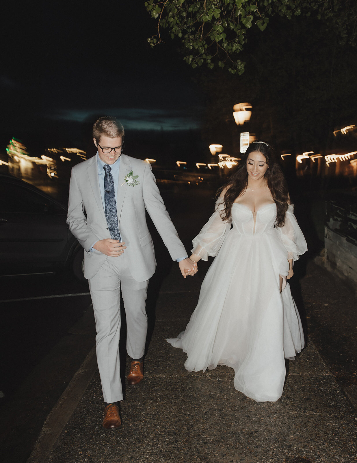 Bride and groom holding each other's hand and walking, happily walking together