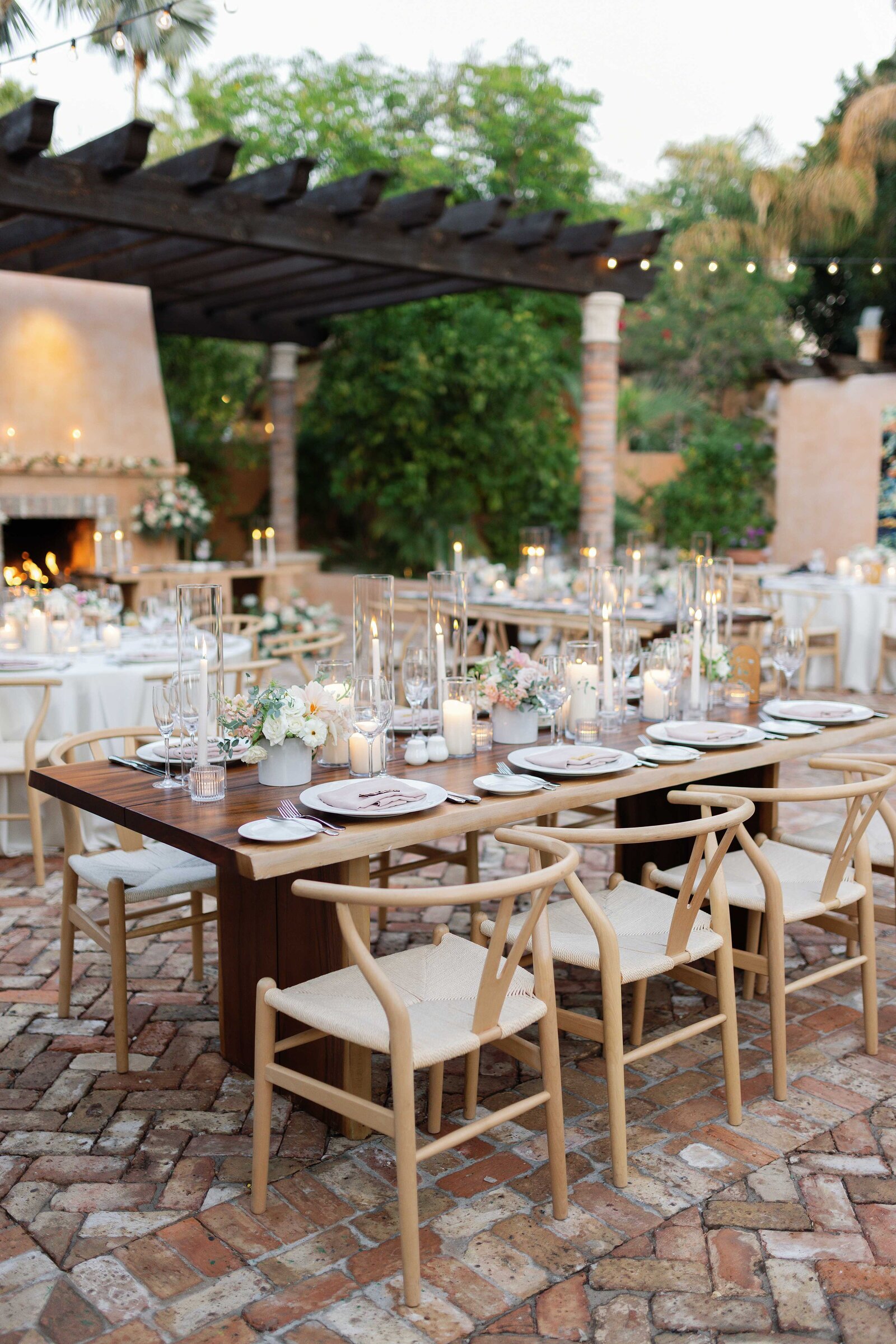 Bride and Groom laugh during a speech given at their reception surrounded by candles.