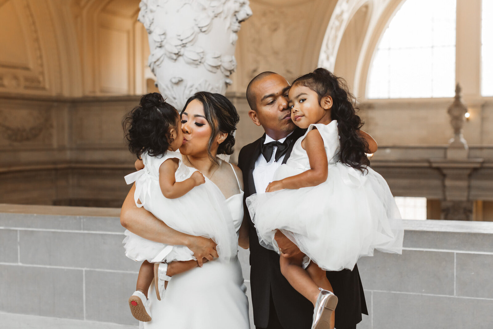 parents with their little girls on their wedding day