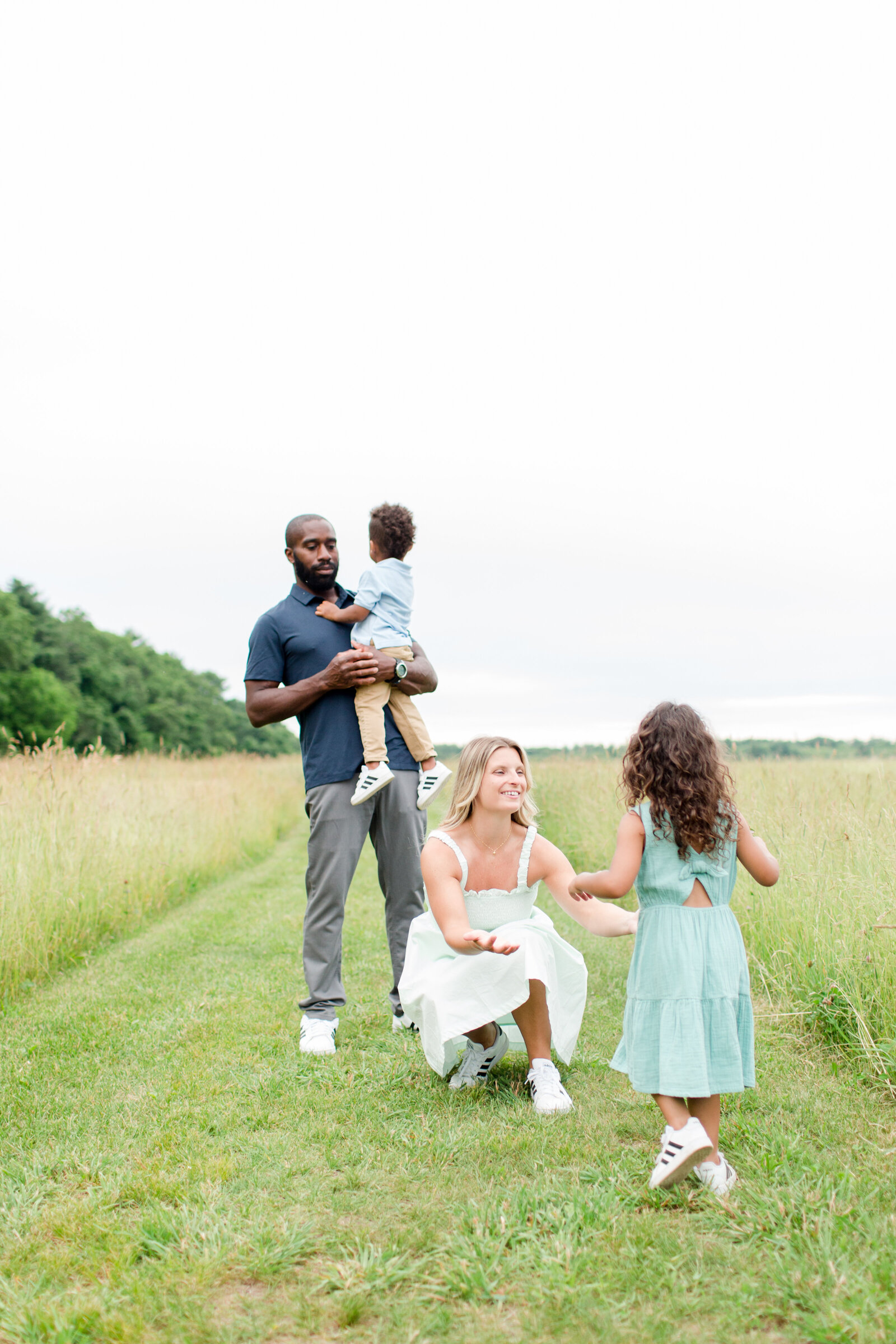 bright and cheery family photos in field in Norfolk Massachusetts