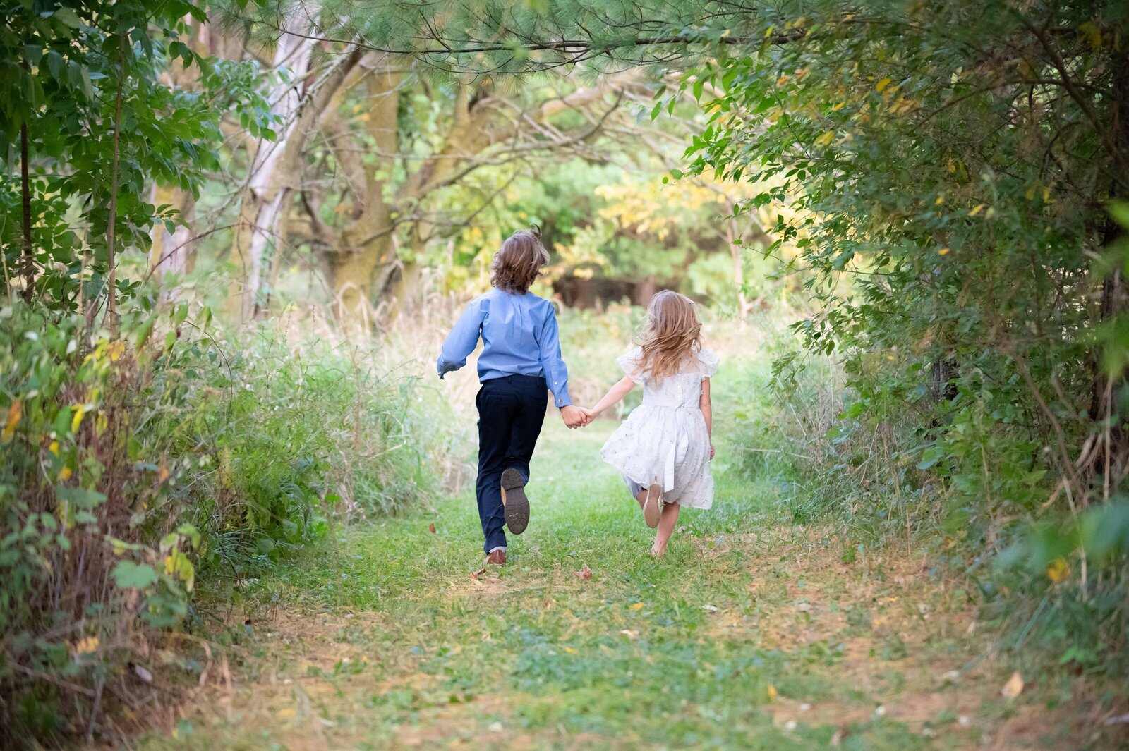 Outdoor family portrait session with children playing at home in Culver, Indiana.