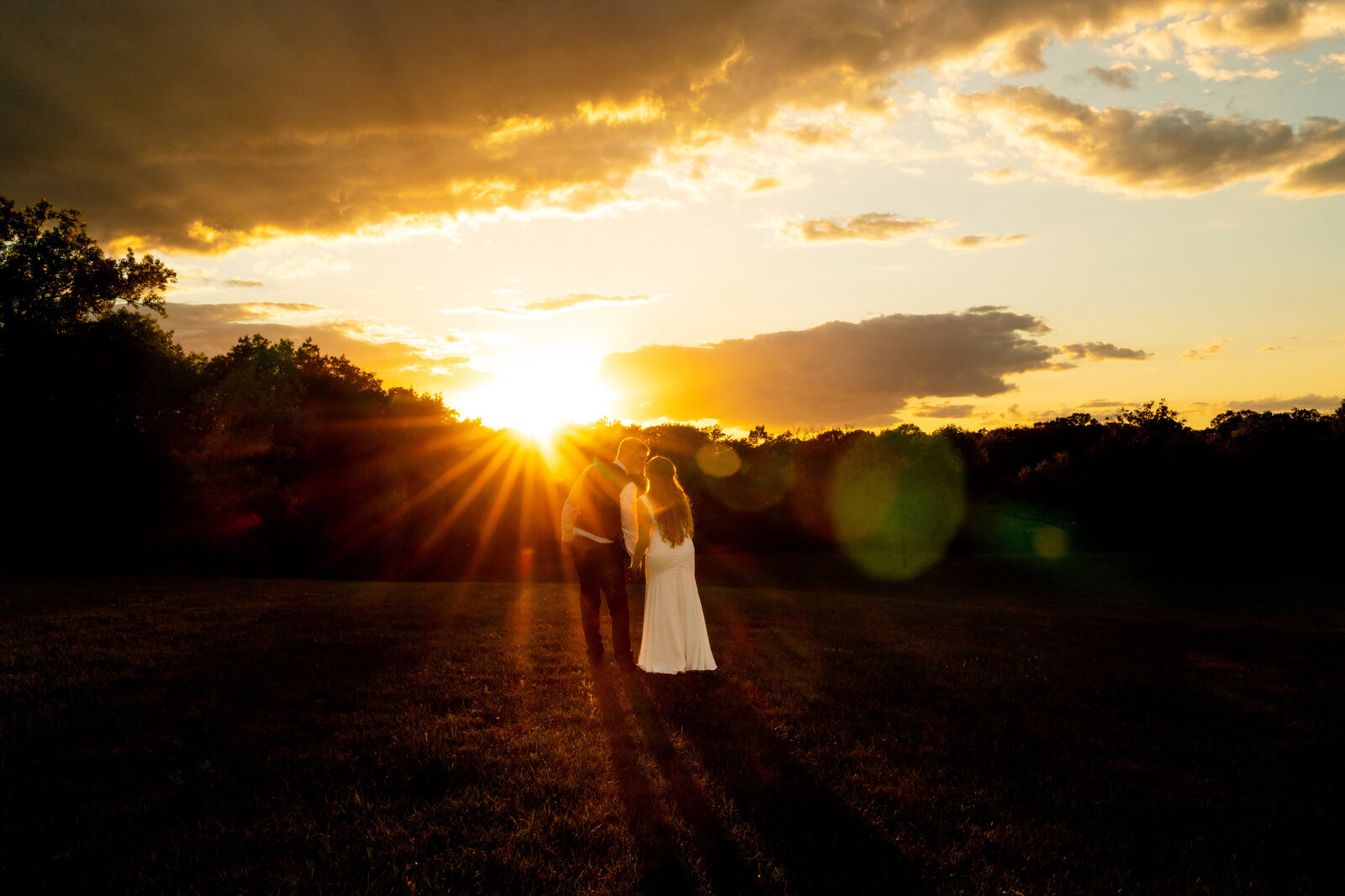 Bride and groom walk into the sunset