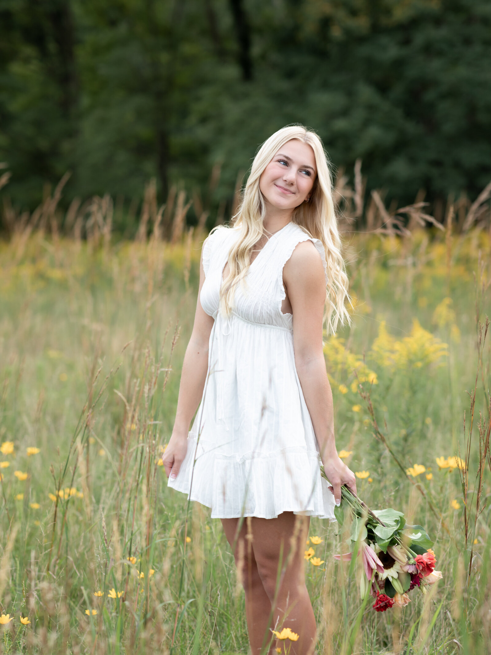 girl in white dress posing for senior photos at westcreek reservation