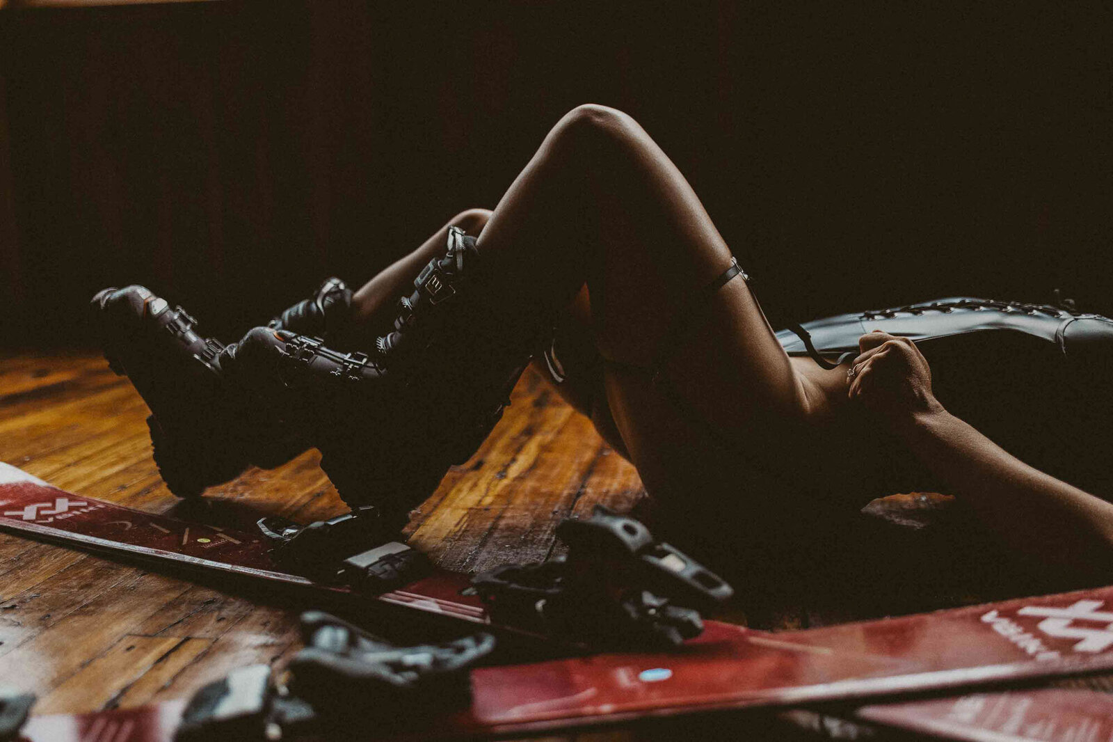 close up of a woman leg laying on the floor wearing a boots