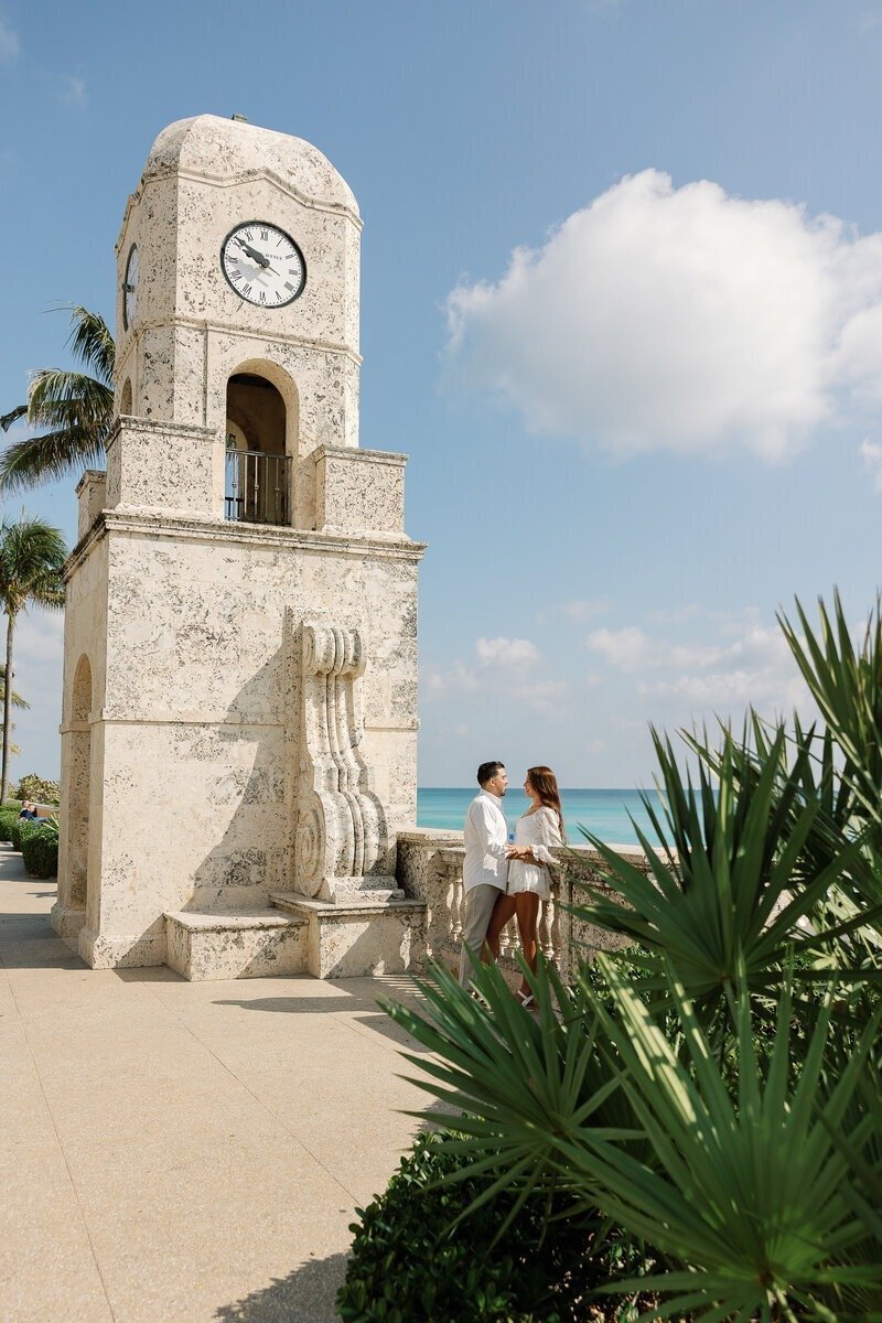couple in front of naples beach landmark