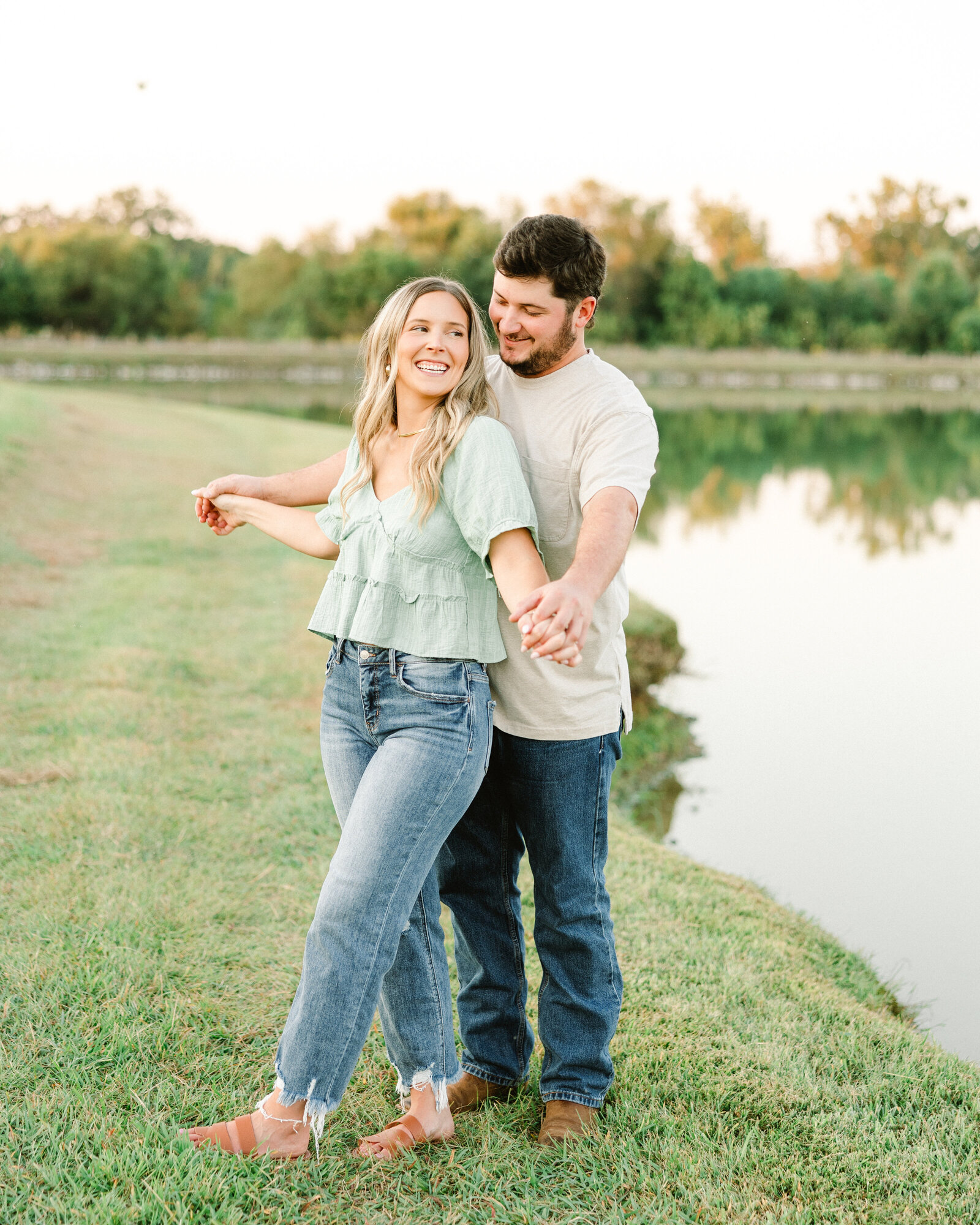 Kelby and Mason enjoying a serene moment in an Alabama meadow, captured by Abby Bell Photography. Personalized and timeless couples photography.