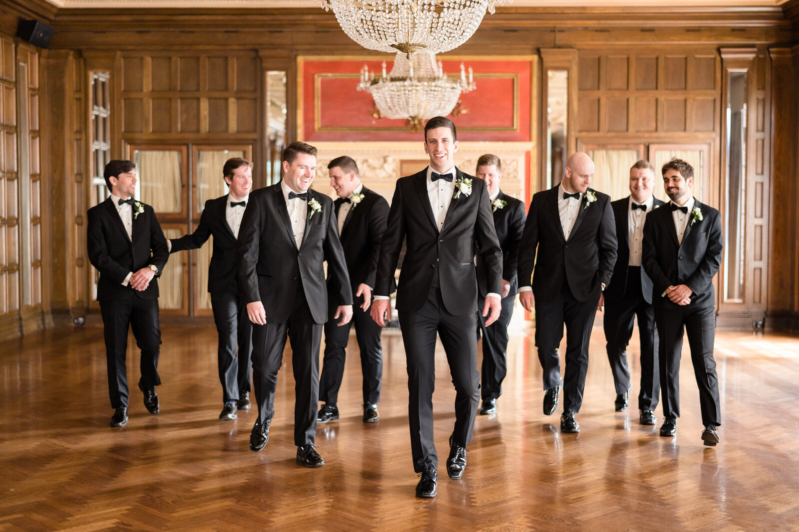 Groom and his groomsmen walk inside the grand ballroom at the Athletic Club of Columbus
