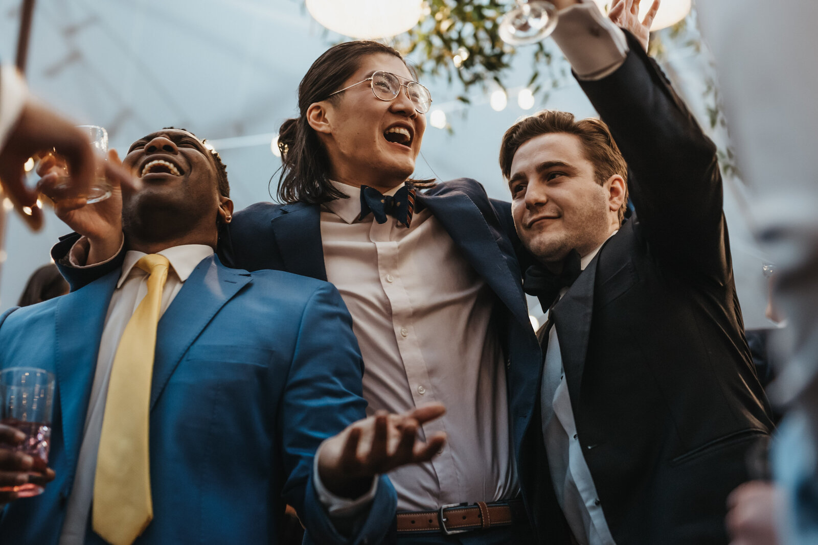 Wedding guests dance together at a reception