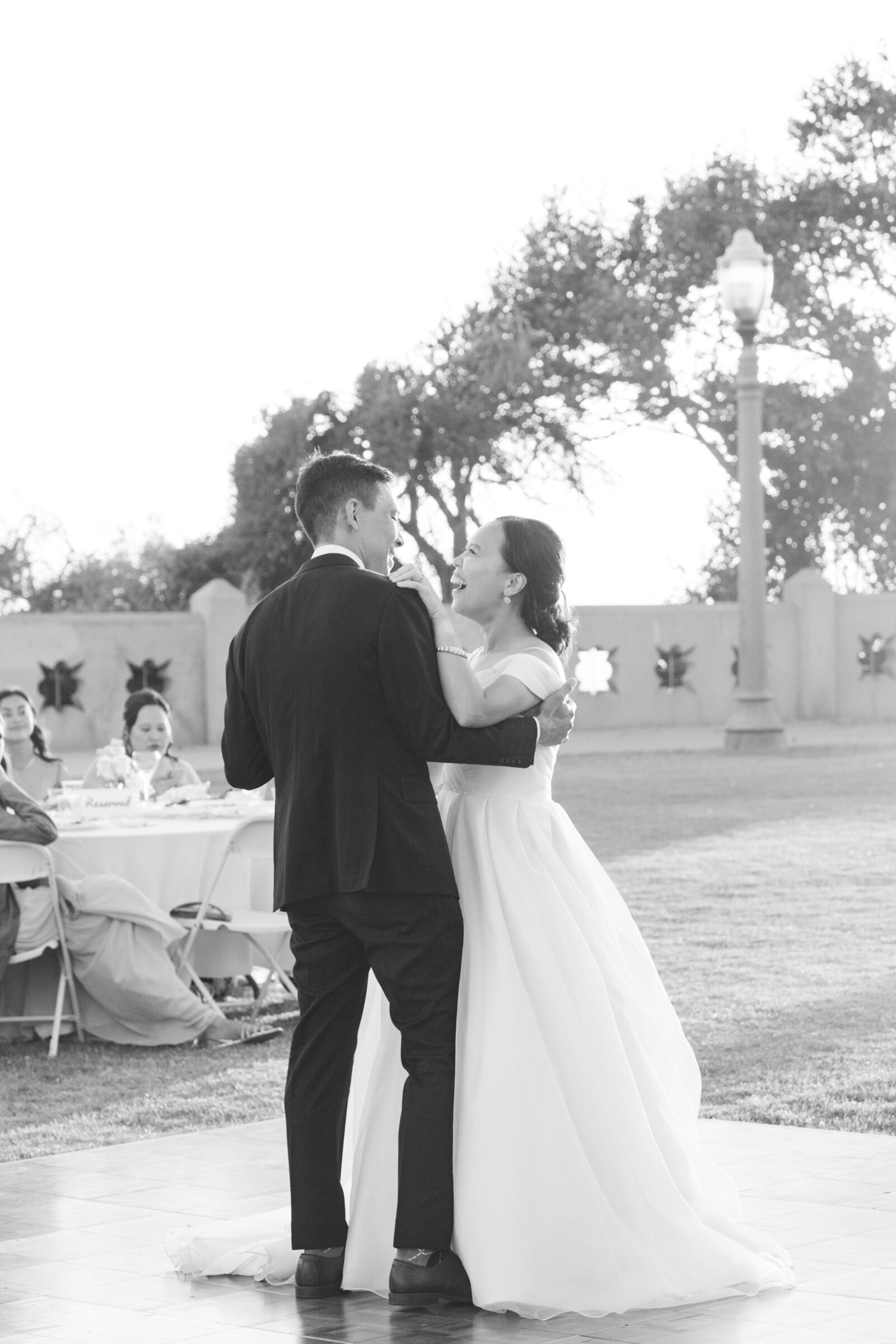 Newlyweds share their fist dance at their beach wedding in Los Angeles.