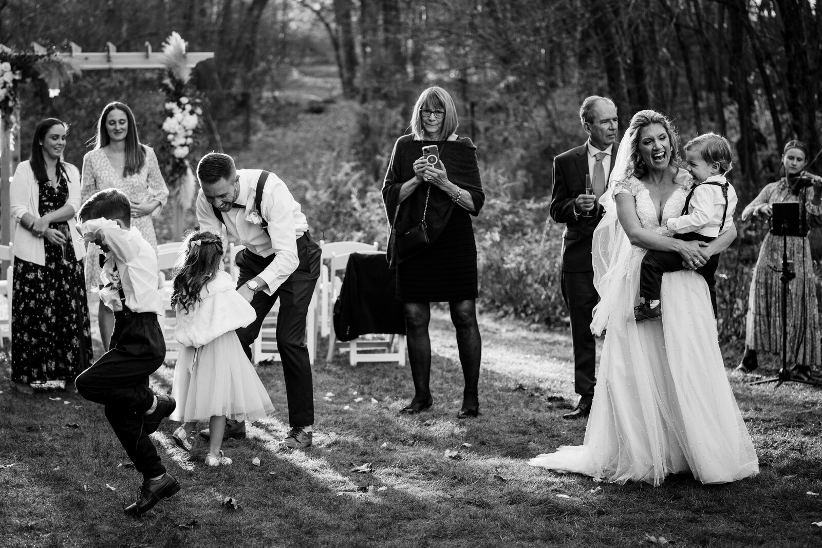 couple dances with family in their backyard elopement ceremony