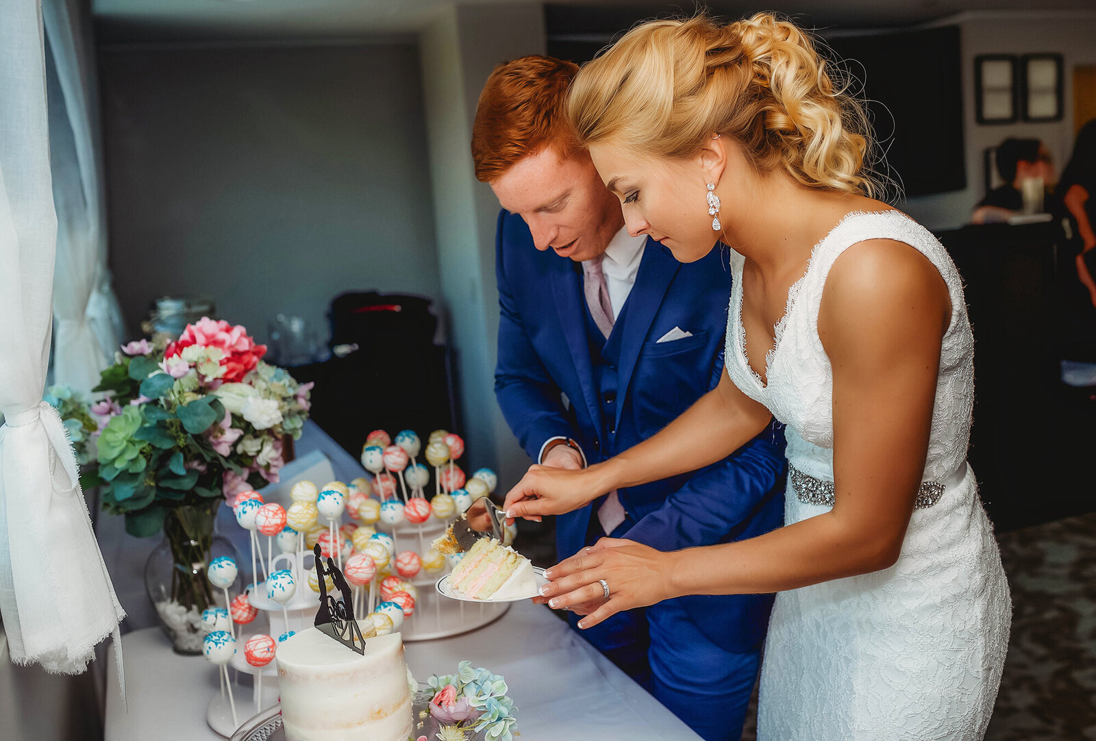 Bride and Groom enjoy wedding cake during their  Micro Wedding at the Capital Club in Asheville, NC.