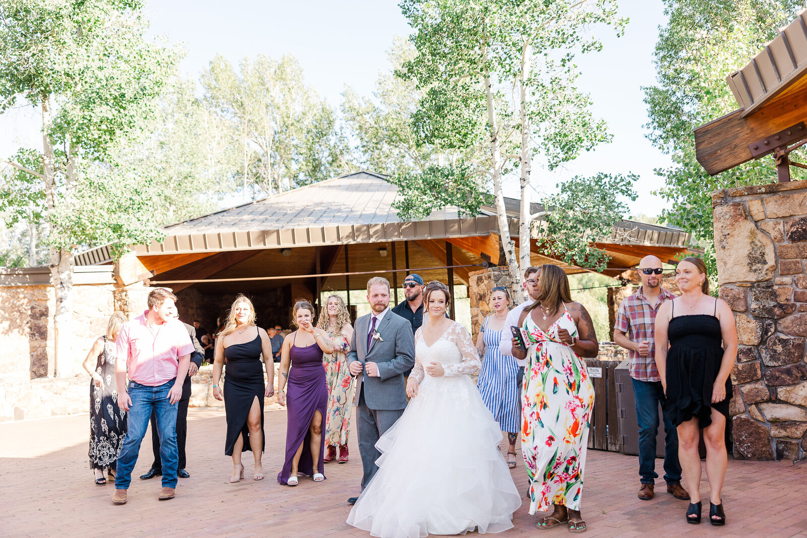 Bride and groom sharing their first dance while a live band plays at a Ridgway State Park wedding reception