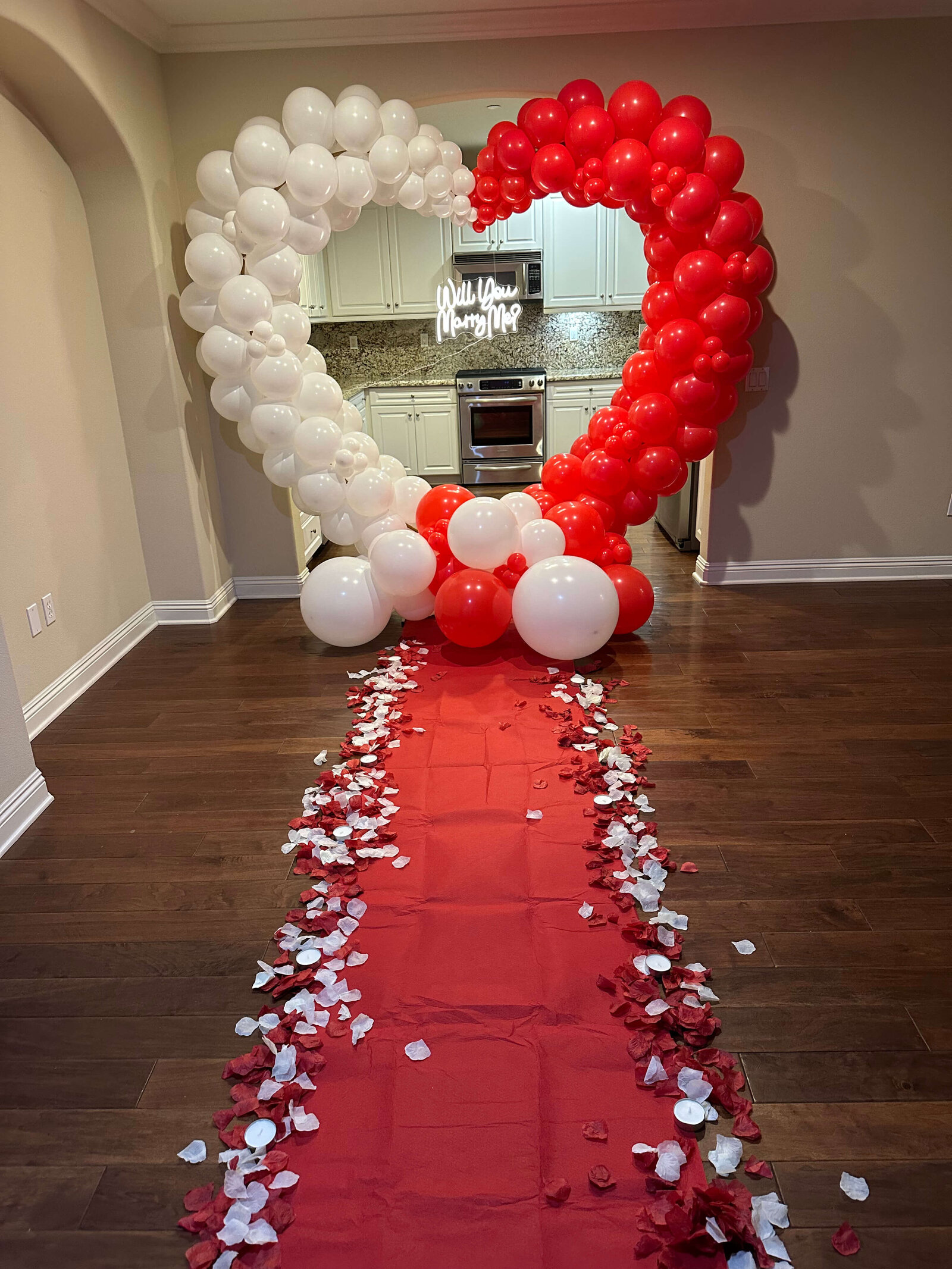 All out balloon decoration for engagement with heart shaped arch