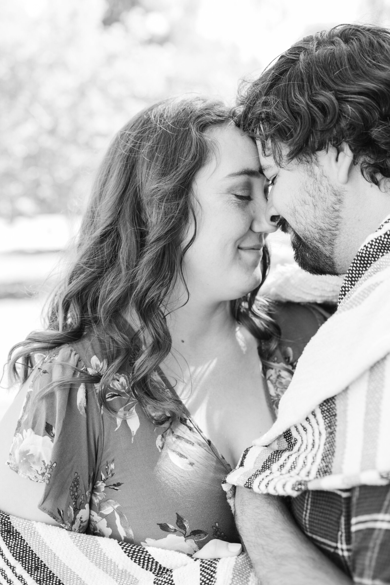 An engaged couple poses for photos in a garden in Los Angeles, Ca.