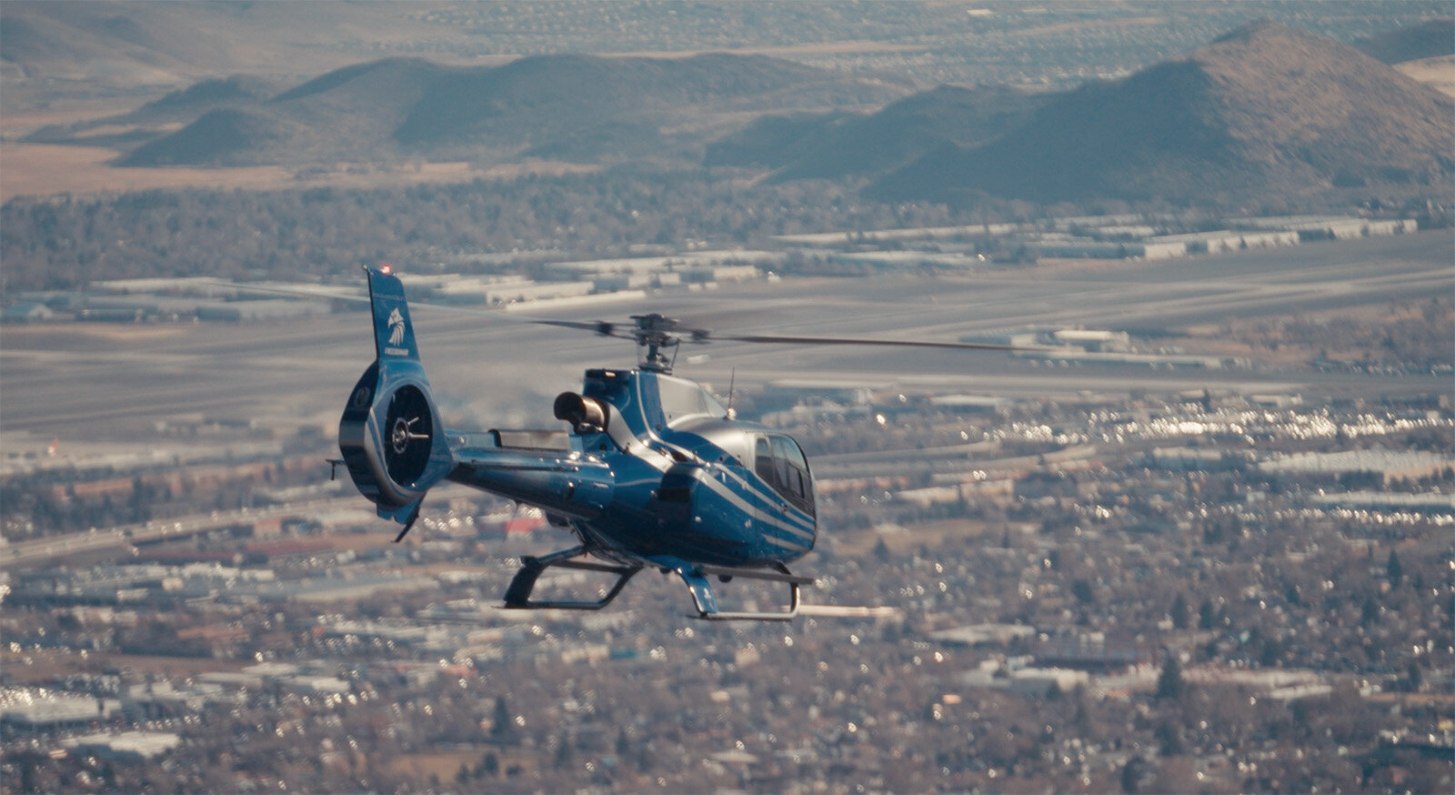 Reno cityscape aerial view with Airbus 130 helicopter