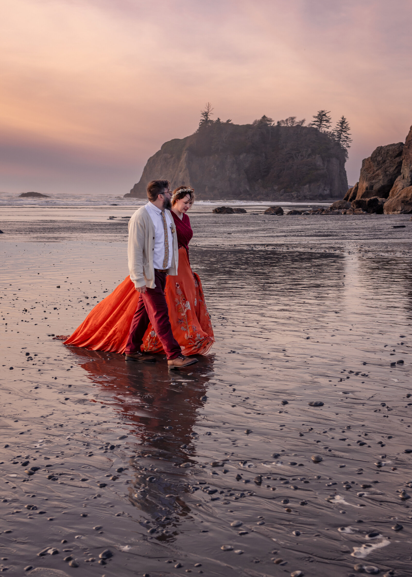 Couple walking along Ruby Beach following their elopement in the Olympic National Park