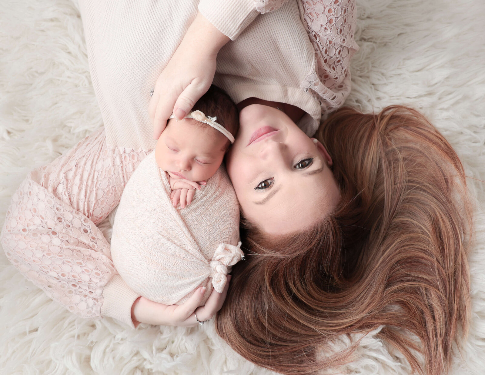 Mom and newborn girl posed at our studio located in Rochester, NY.