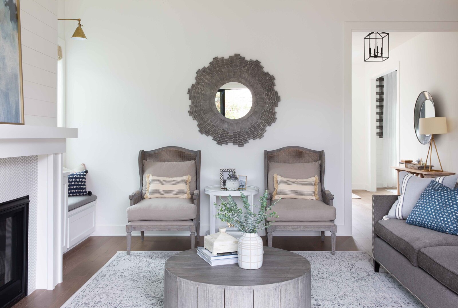 Nuela Designs_Classic Living room with French Caning Wing Chairs and Nailhead Sofa wiith Built-in Seating