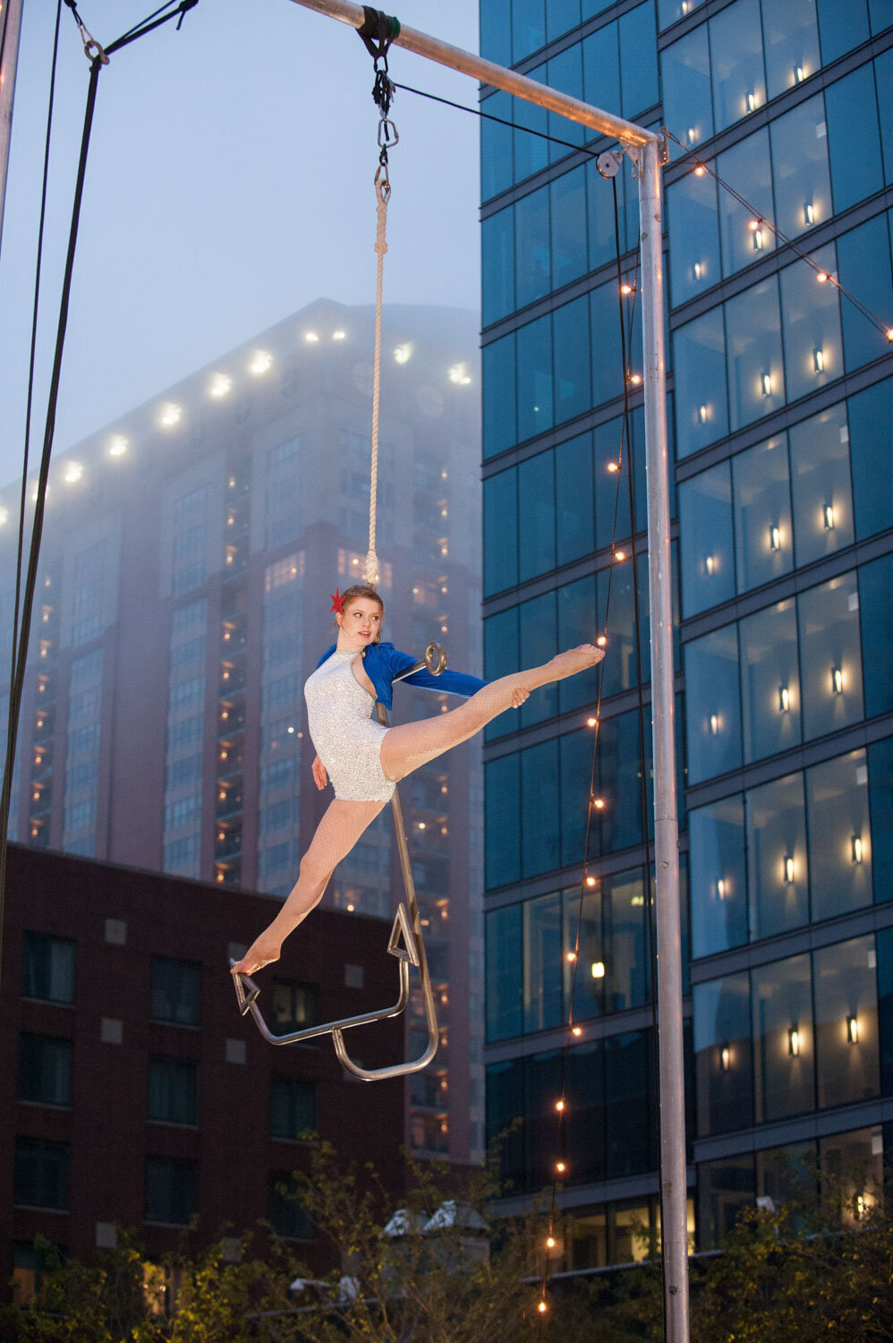 A woman is hanging from a rope in the air
