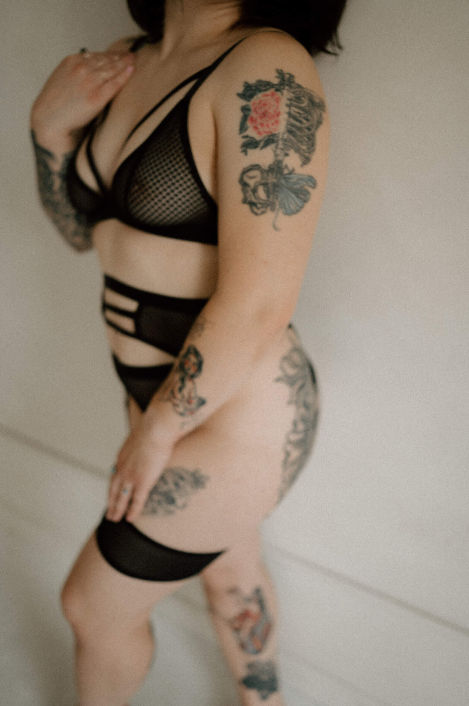 womans body wearing balck netted lingerie set