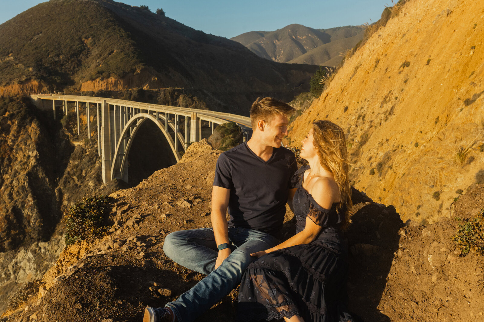A couple poses for their engagement photos in Big Sur, California.