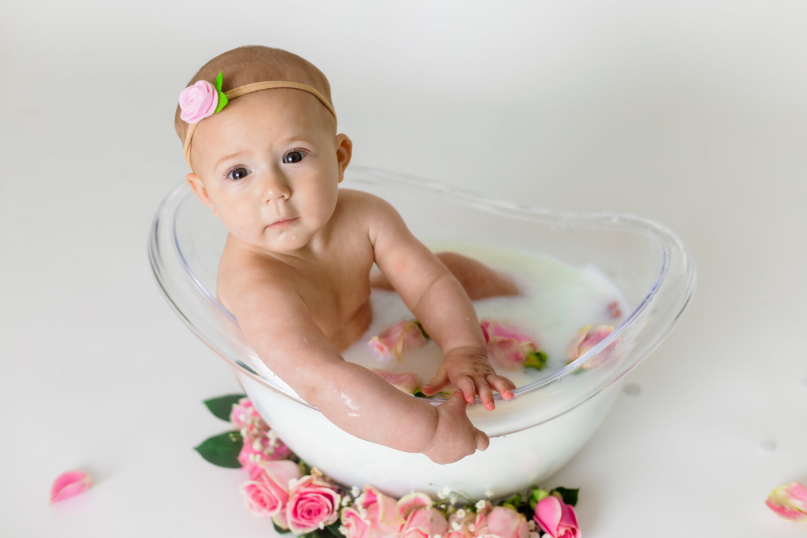 Milestone Photographer, a baby sits in a tub of milk and flowers