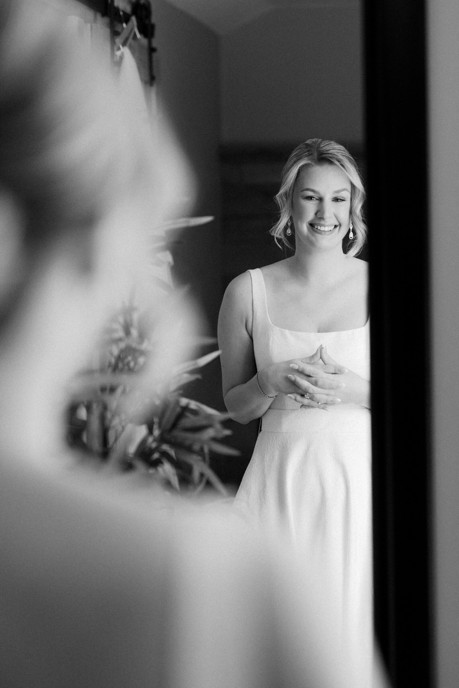 Elegant black-and-white bridal portrait showcasing a timeless updo styled by Promise Artistry.