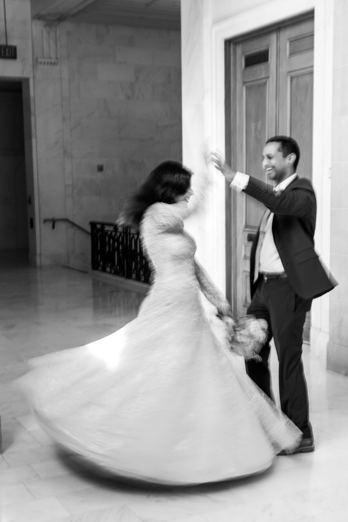 couple twirling at city hall