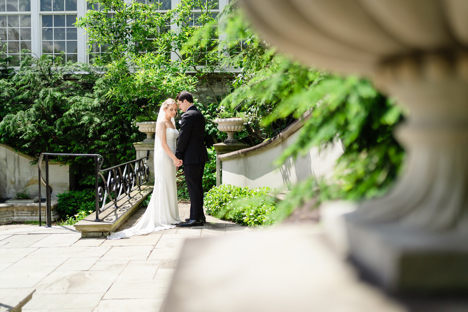 Bride and groom embrace each other in the Bride's Garden at the Franklin Park Conservatory