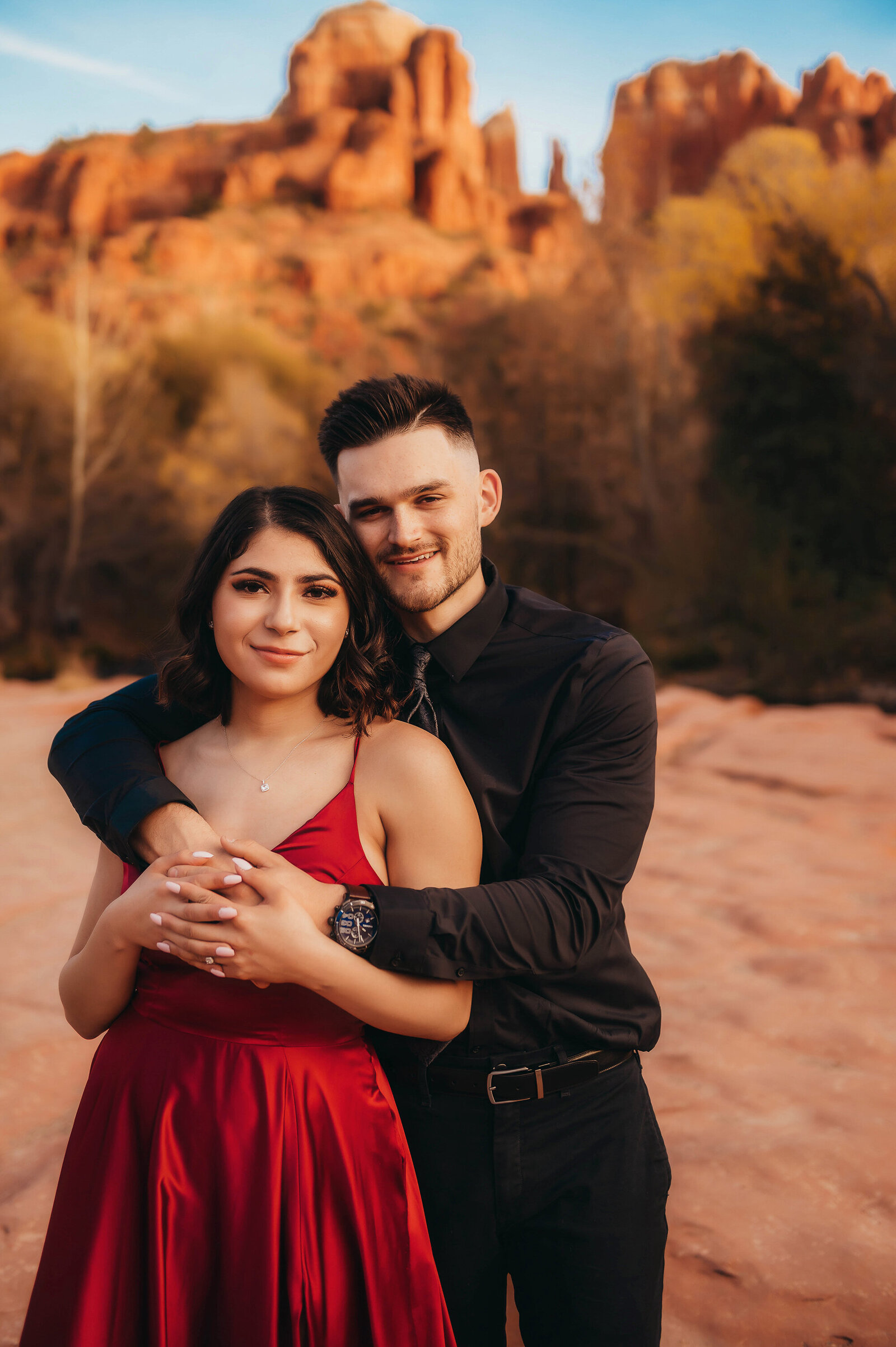 Engaged couple poses for Engagement Photos at Cathedral Rock in Sedona Arizona.