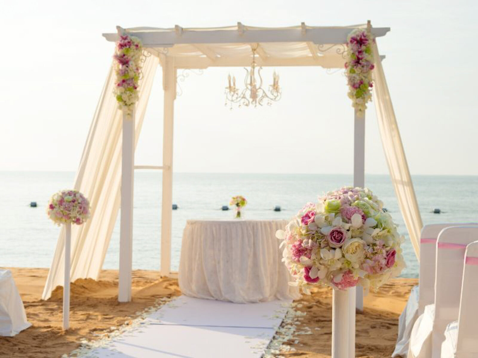 Beach wedding ceremony site with  elegant florals