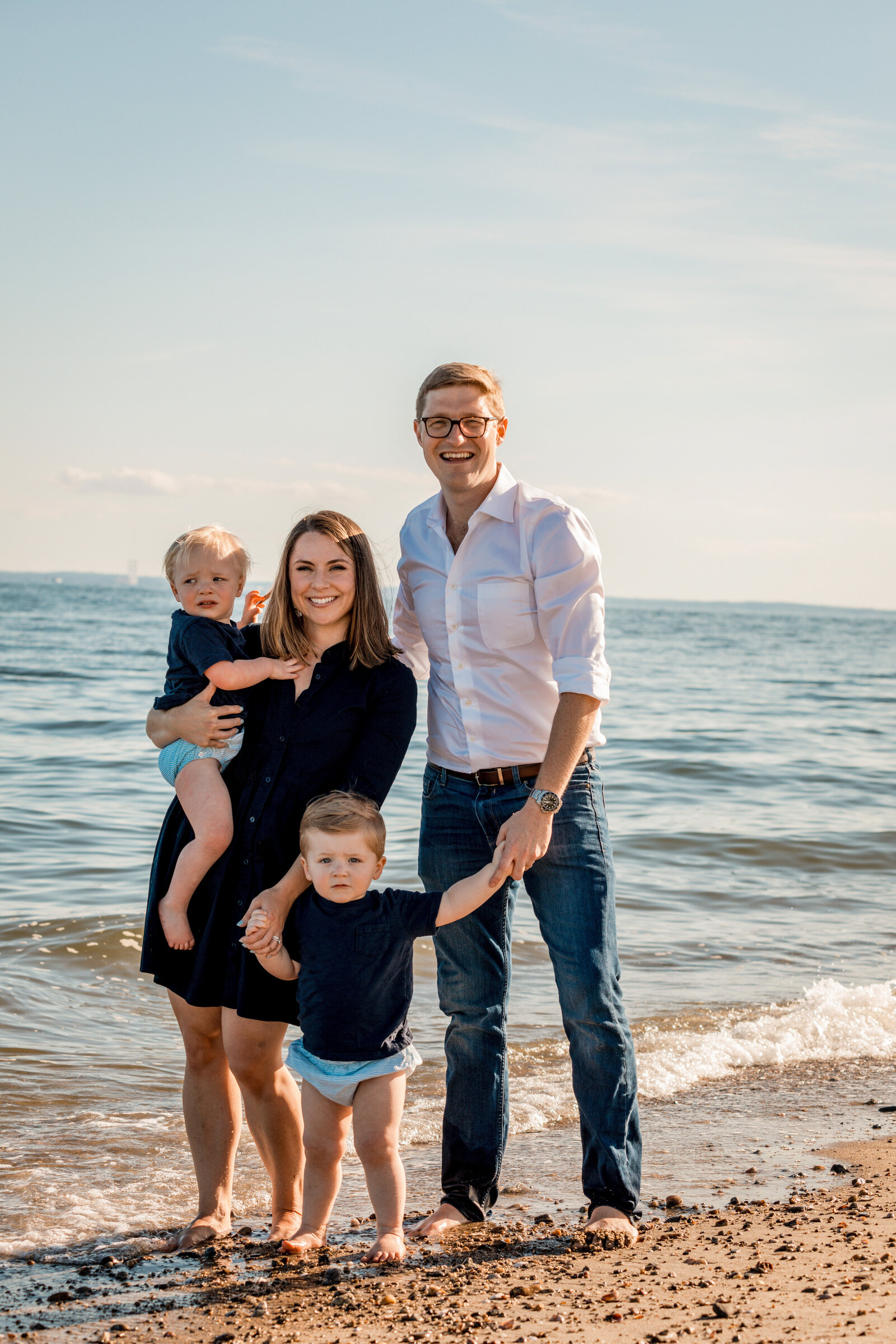 family smiling on the westport beach