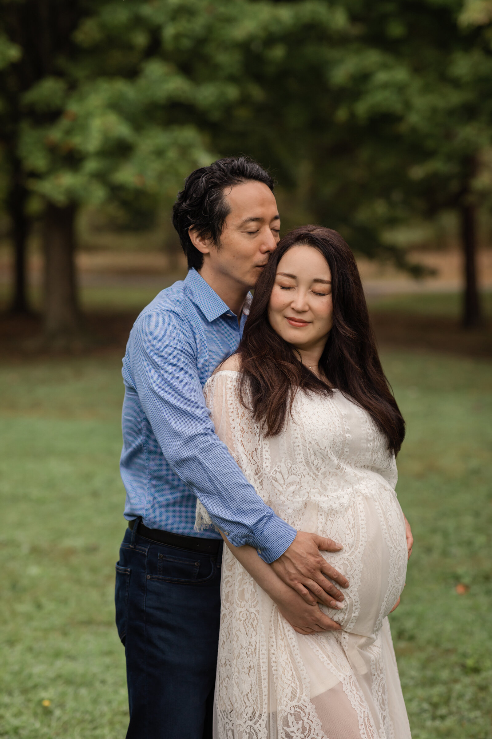 husband and wife holding pregnant belly for maternity photos at squires castle Cleveland maternity photographer