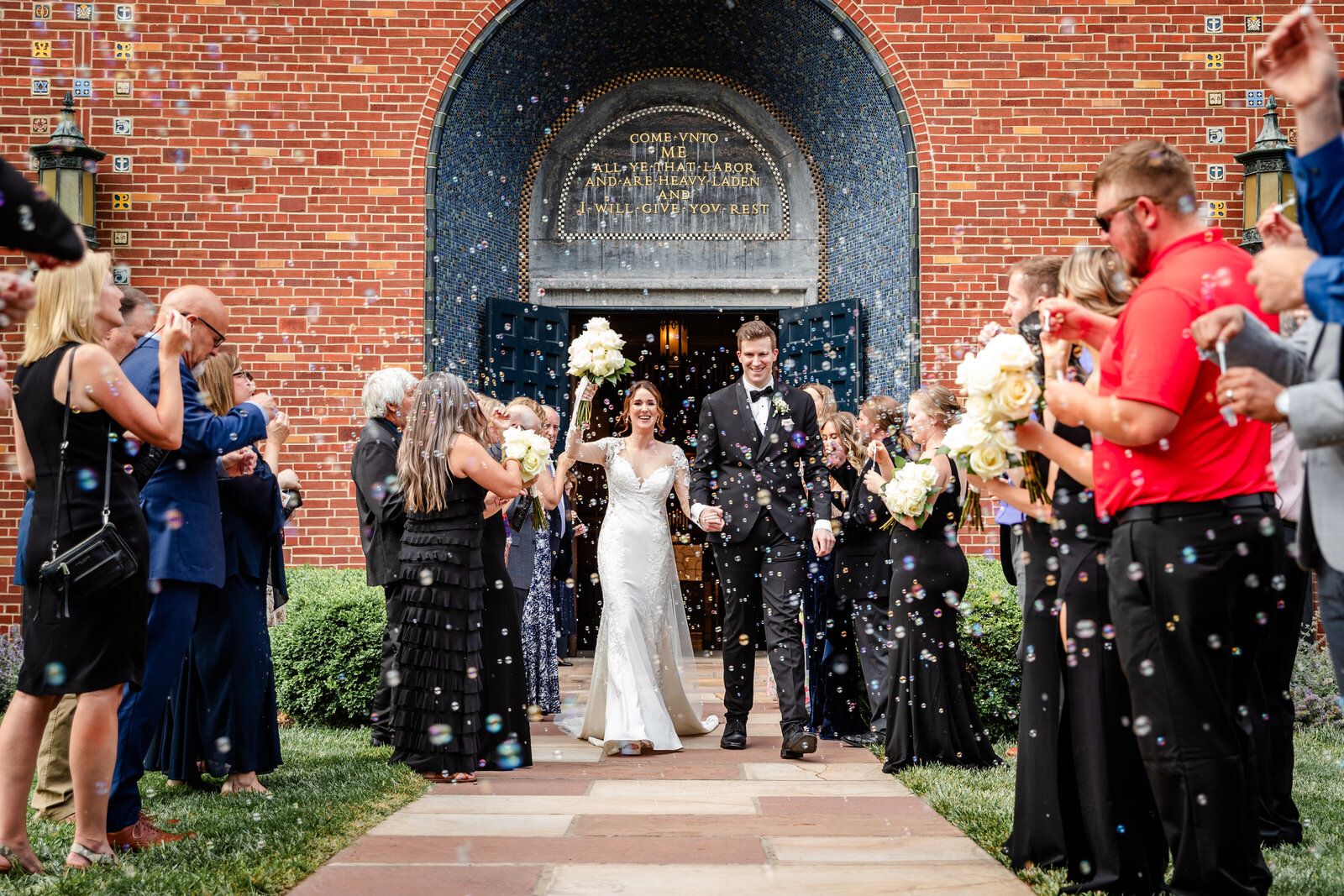 Bride and Groom exiting church with bubbles