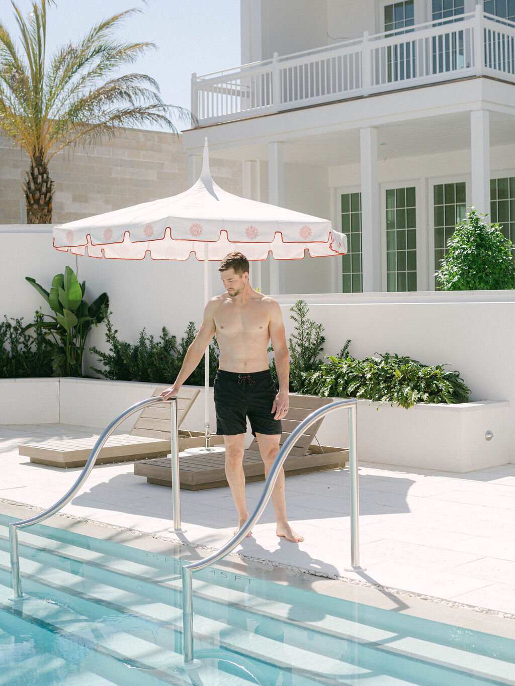 man by pool on honeymoon at Kaiya Beach Resort