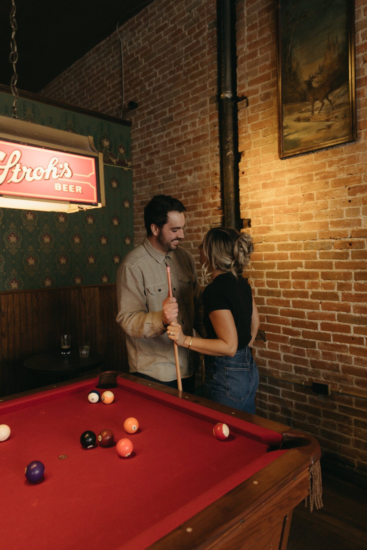 Couple with pool table taken by destination wedding photographers