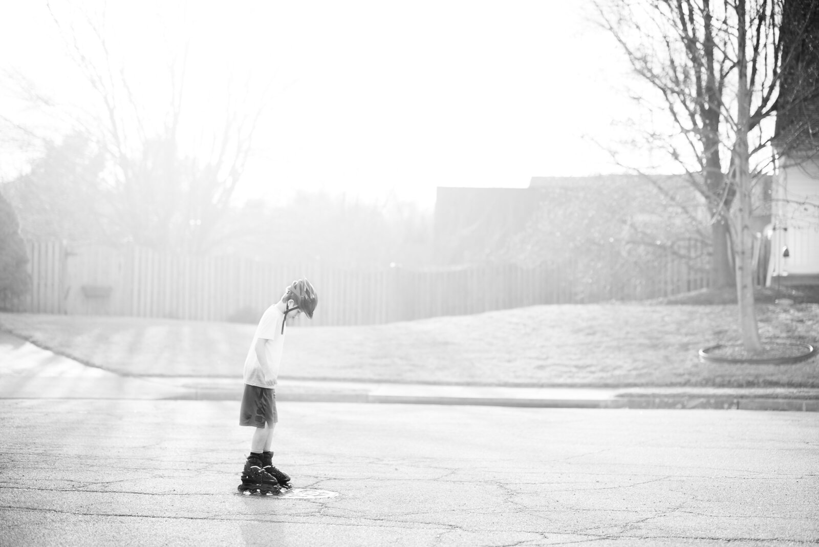 Black and White photo of a Boy Rollerblading in the street. Photo taken by Dripping SPrings based Lydia Teague Photography.