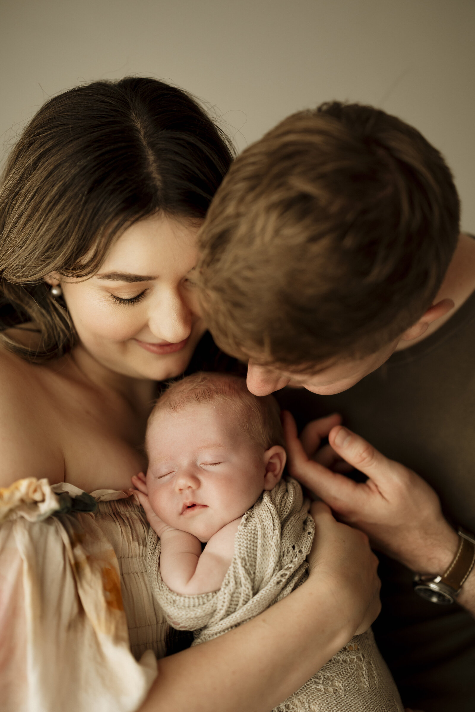 Classic newborn family portraits in Perth – simple, elegant, and focused on the connection between parents and baby.