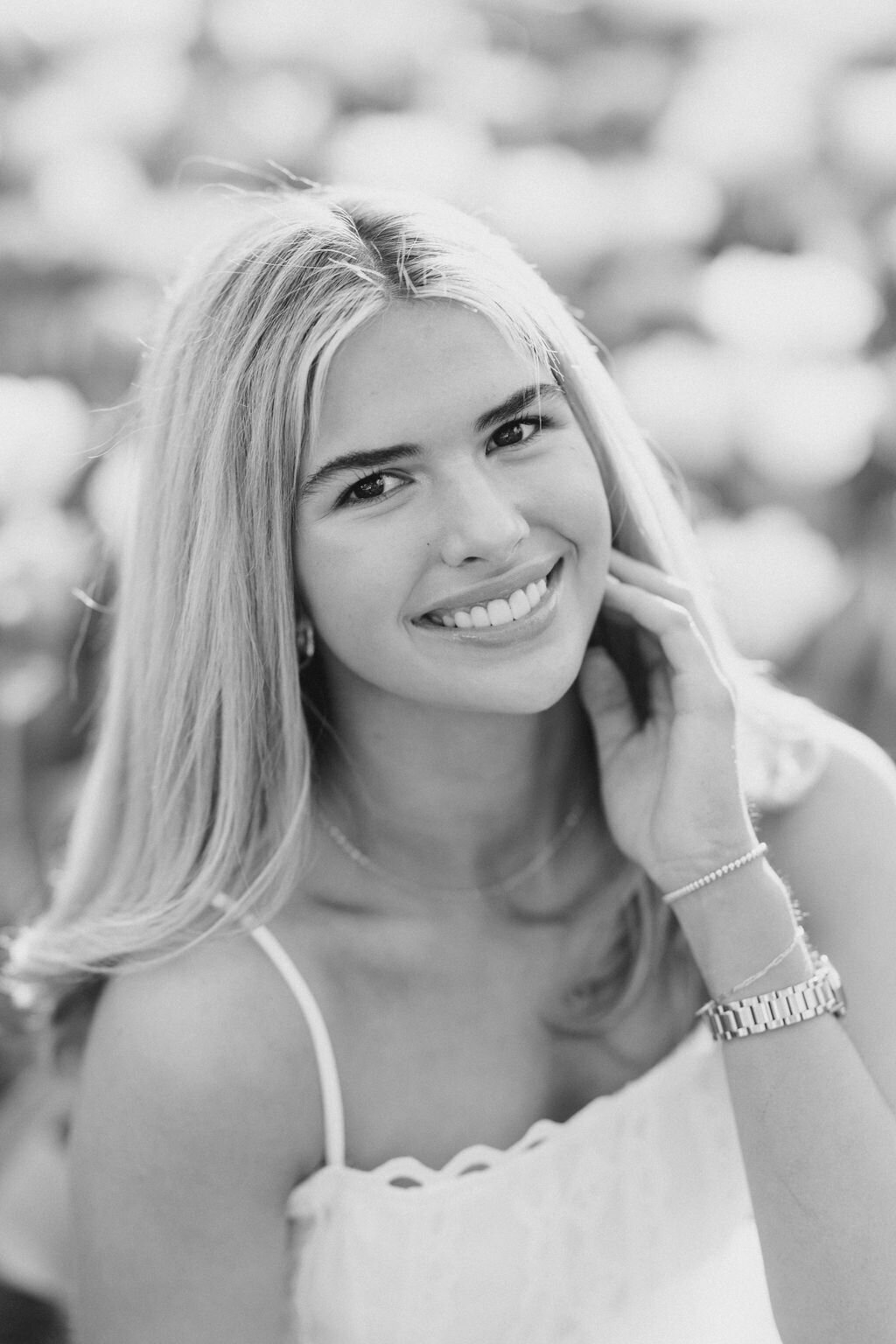 Girl in white dress smiles at Athens botanical gardens