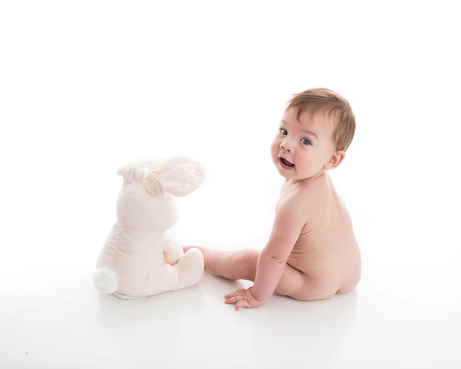 cute baby picture on white with stuffed animal
