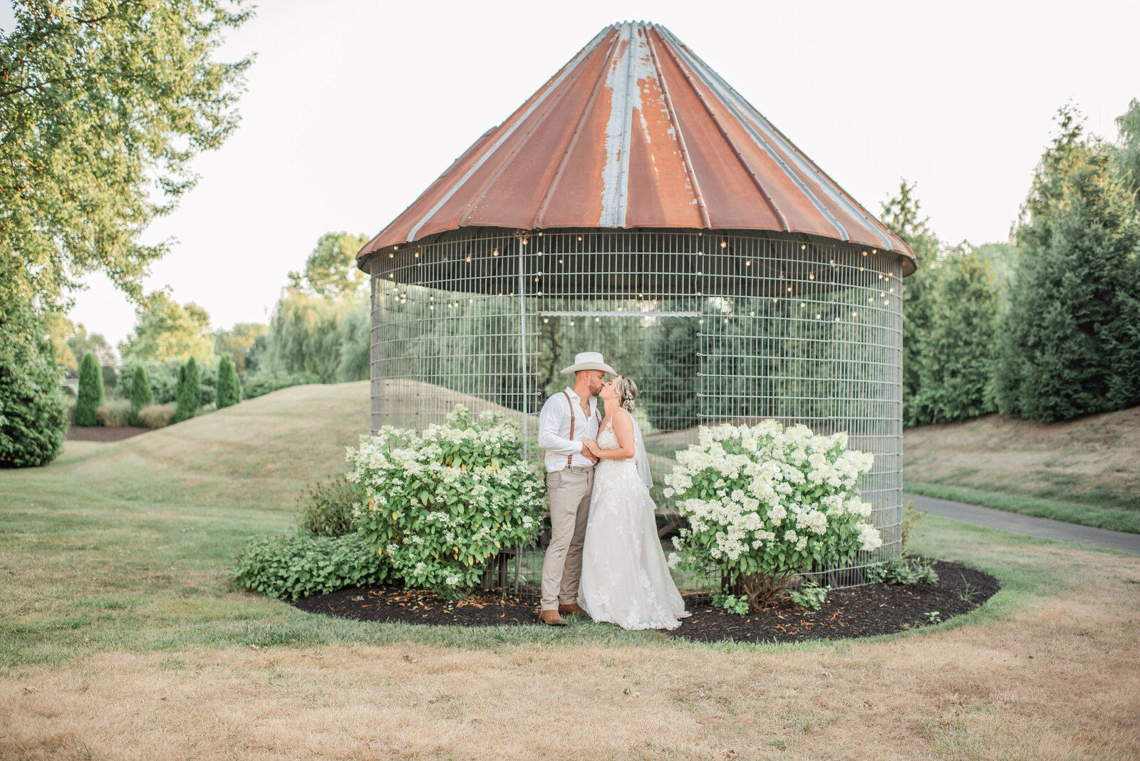 sweet bride and groom embrace for a romantic moment at their stoltzfus homestead & garden wedding - lancaster wedding photographer