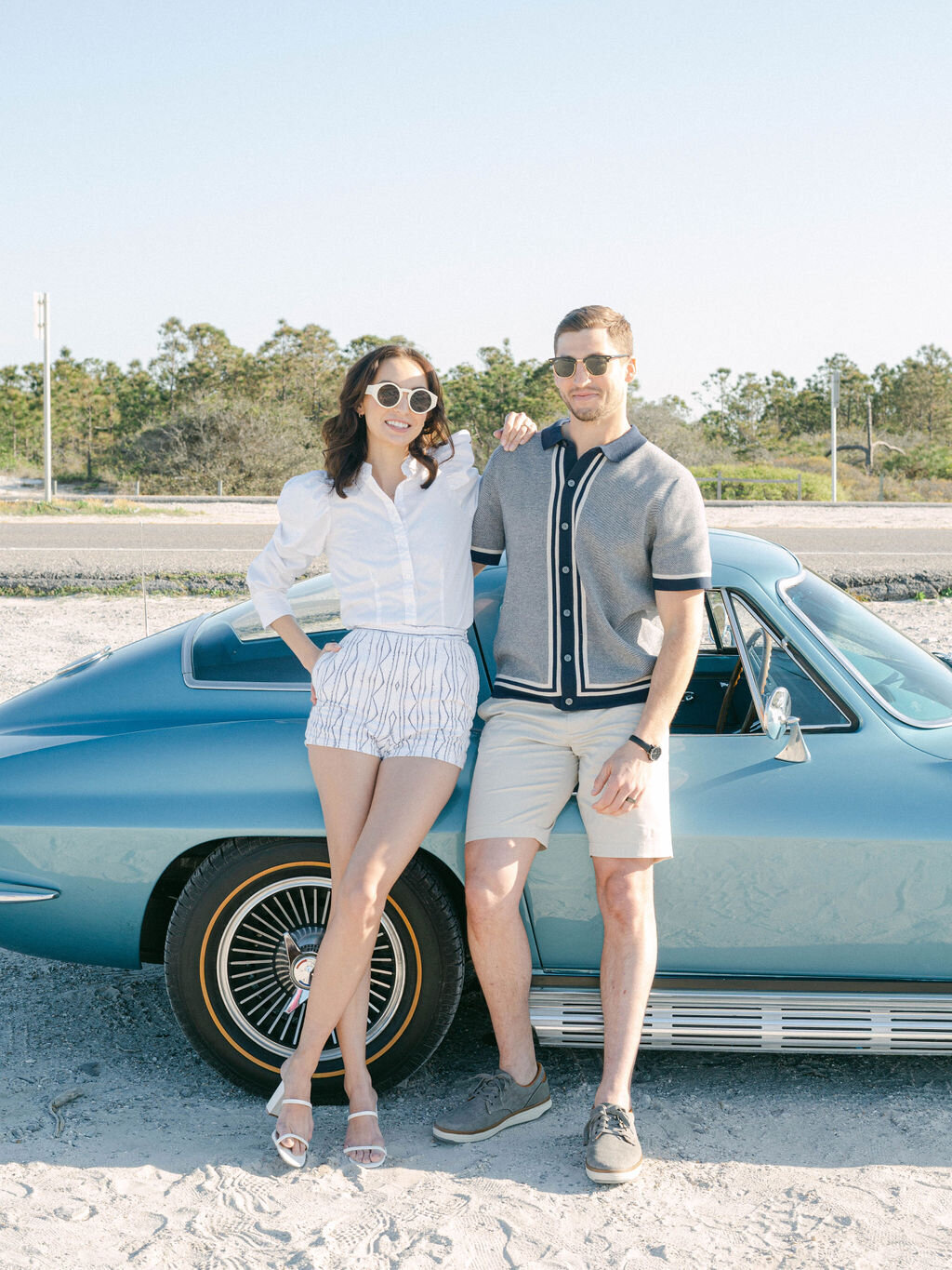 couple standing in front of sports car at Kaiya Beach Resort