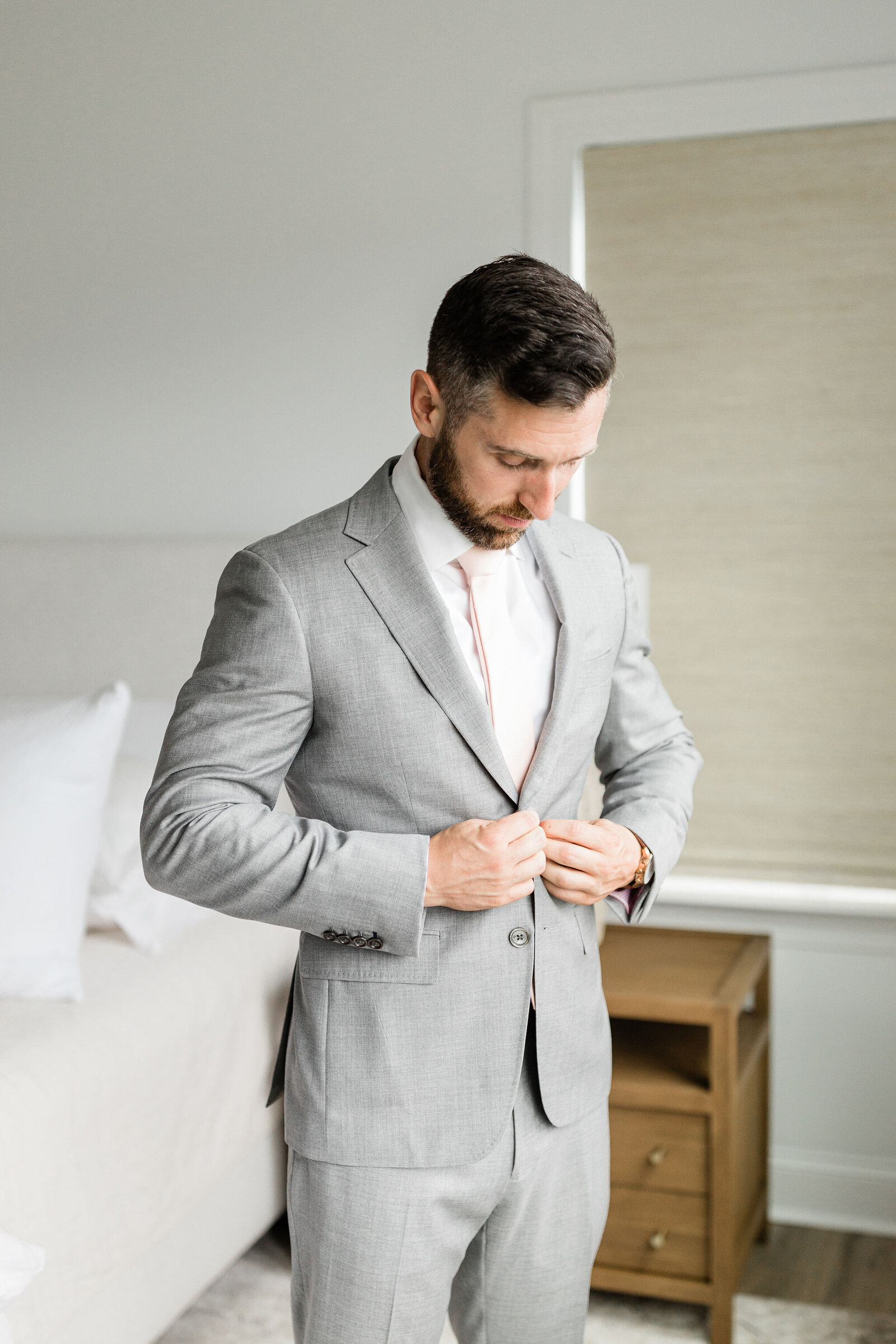 Groom Buttoning his Suit | Raleigh NC | The Axtells Photo and Film