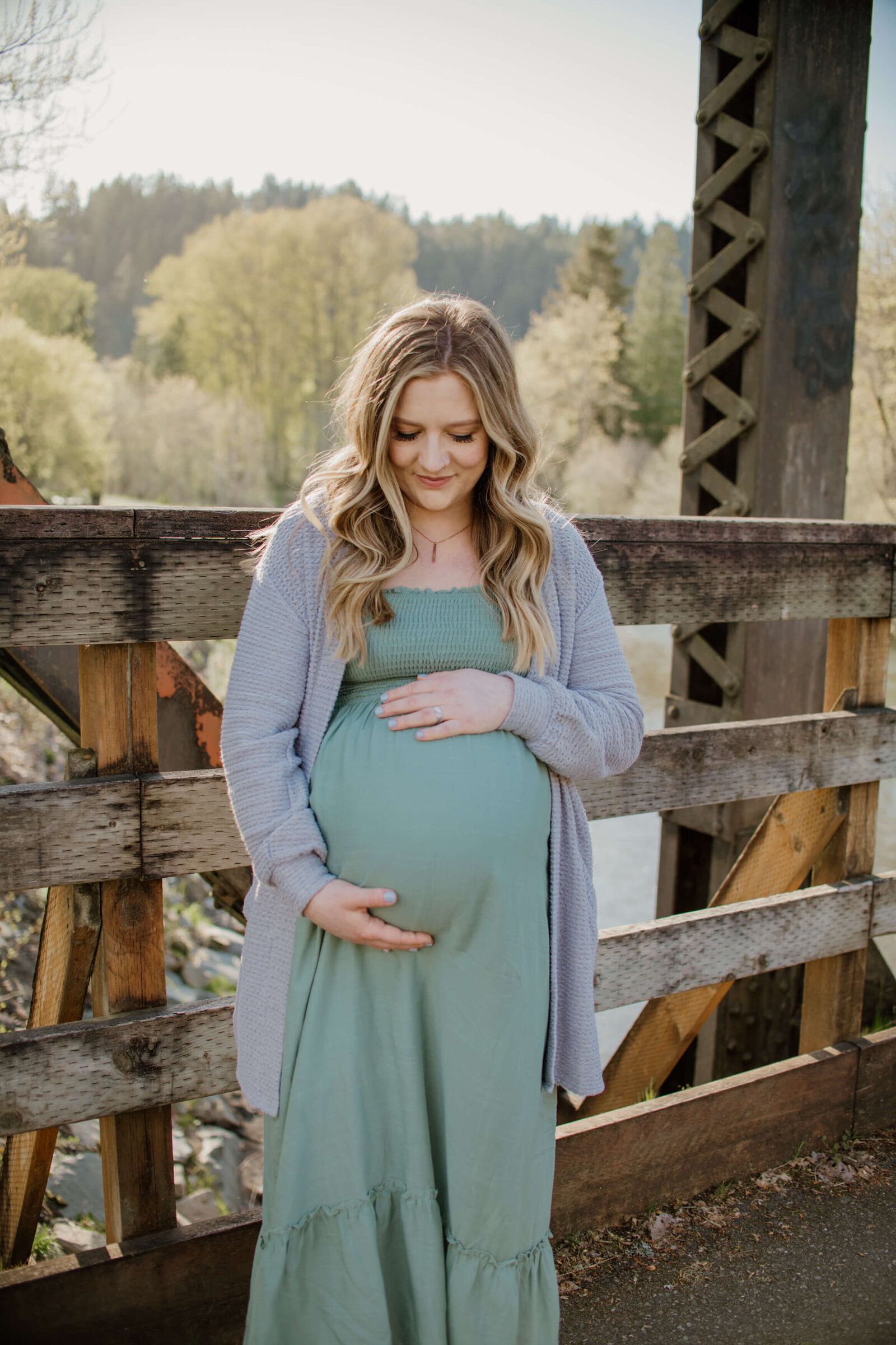 Pregnant woman looking down at her belly.