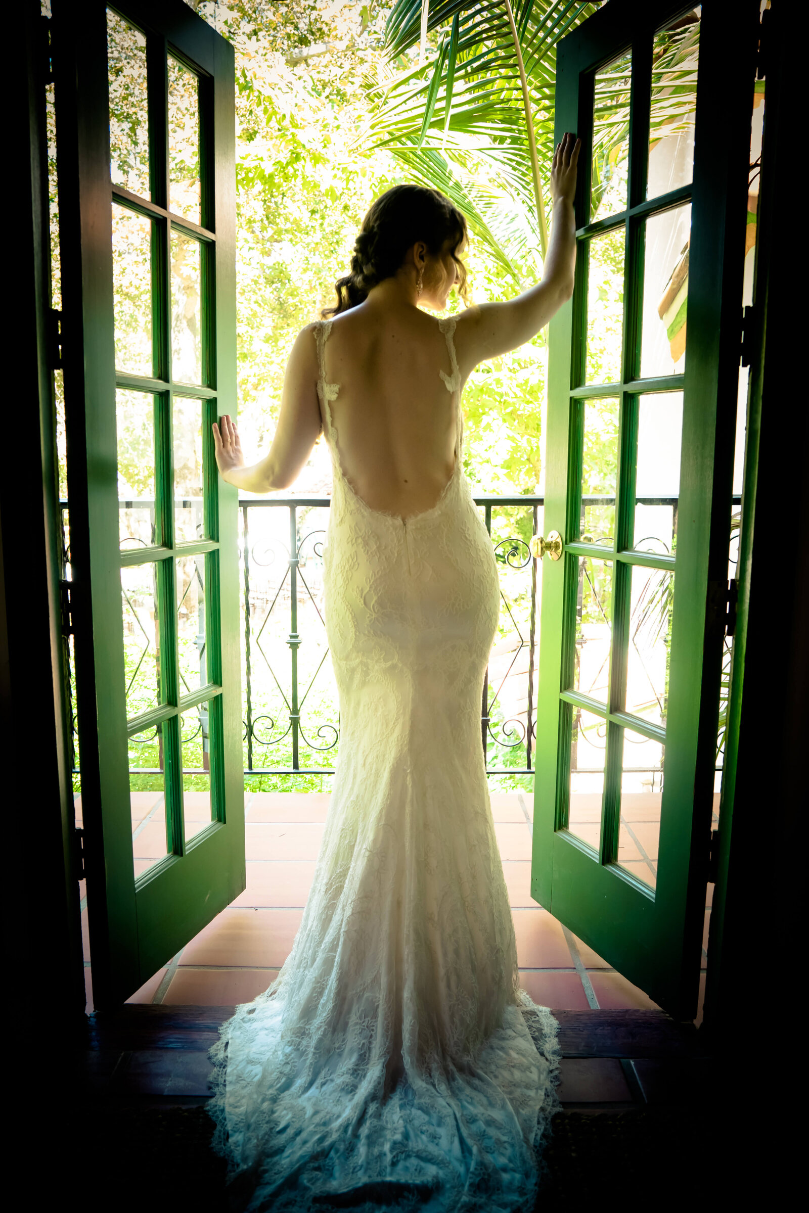 Newport Beach Wedding Photographer bride standing in doorway with low back dress