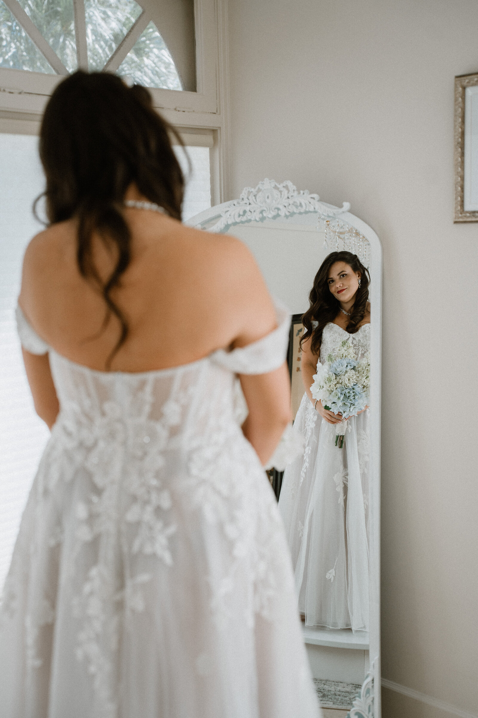 bride admiring herself in wedding dress