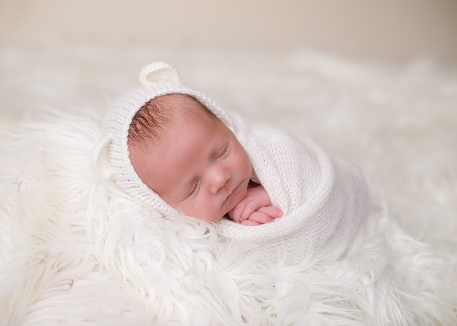 newborn baby wrapped in white