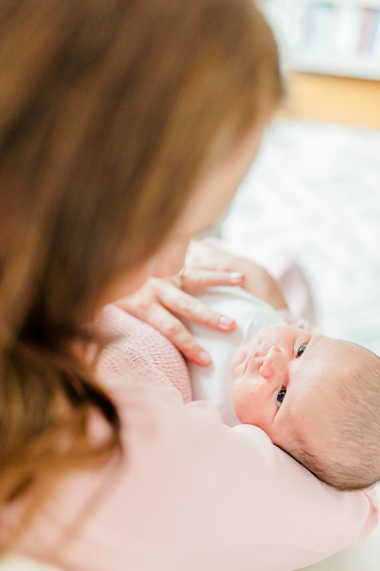 Newborn looks up at mom's face