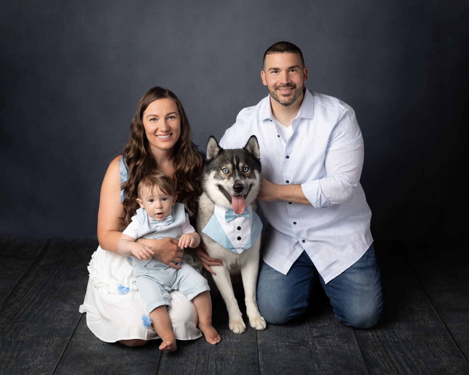 parents and one year old son posed with dog for studio portraits cleveland family photography